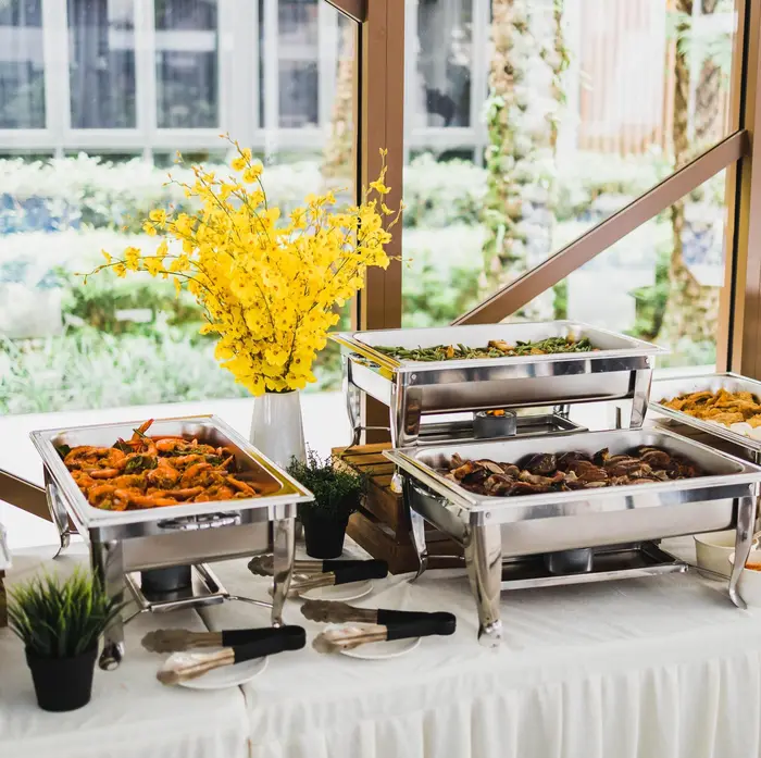 Buffet catering setup with chafing dishes at a corporate event in Singapore