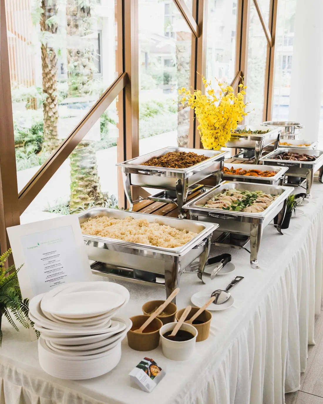 Buffet catering being set up with chafing dishes at a venue in Singapore