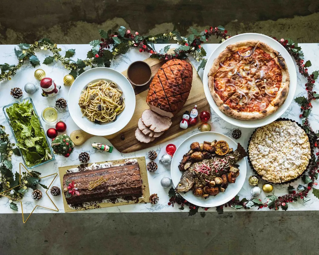 Christmas catering spread with roast, pasta and festive sides laid out in Singapore