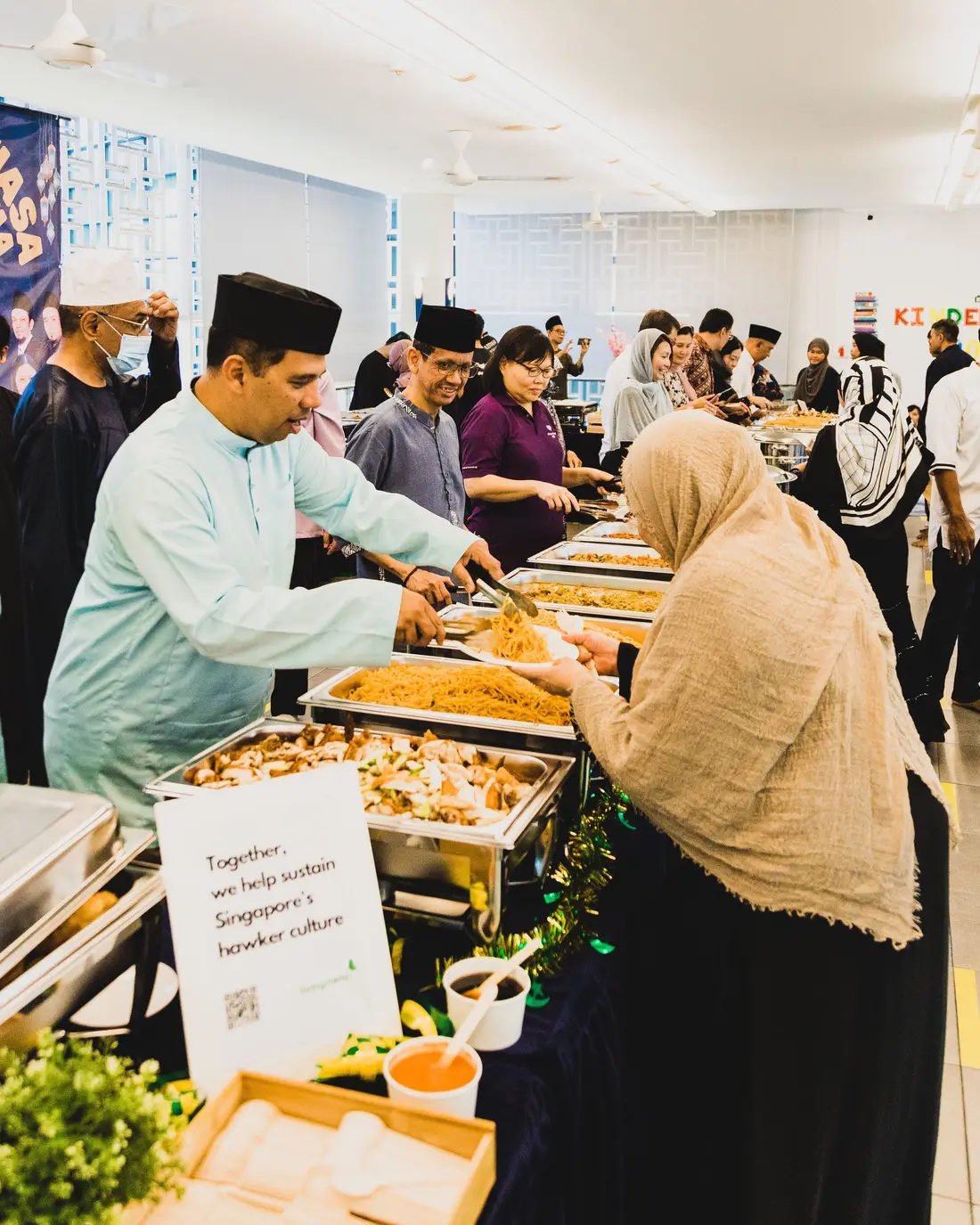 Guests serving themselves from a Hari Raya buffet catering spread in Singapore