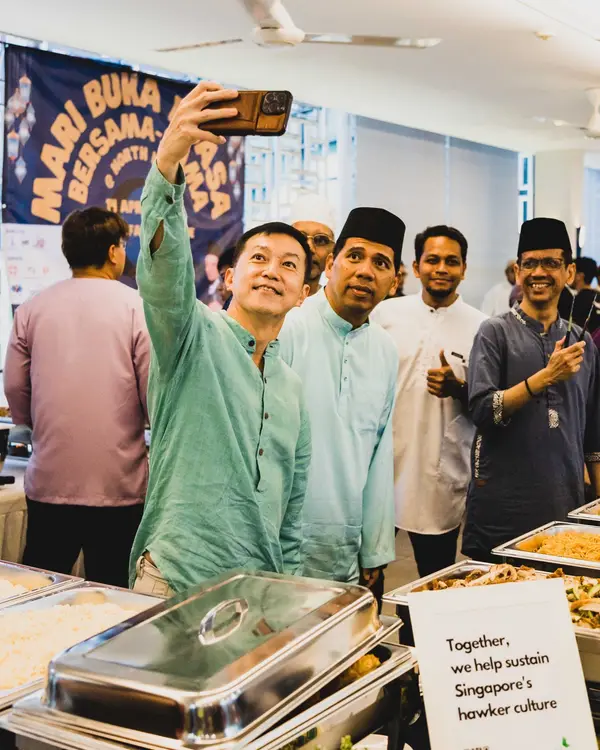 Colleagues celebrating Hari Raya at a company event with halal catering