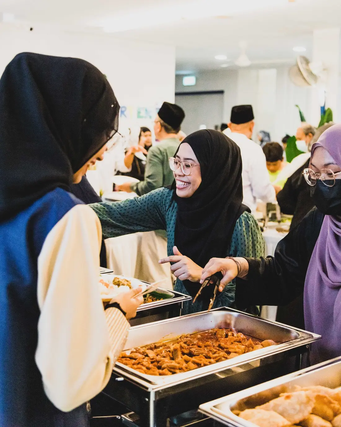Guest serving from a Hari Raya open house catering spread in Singapore