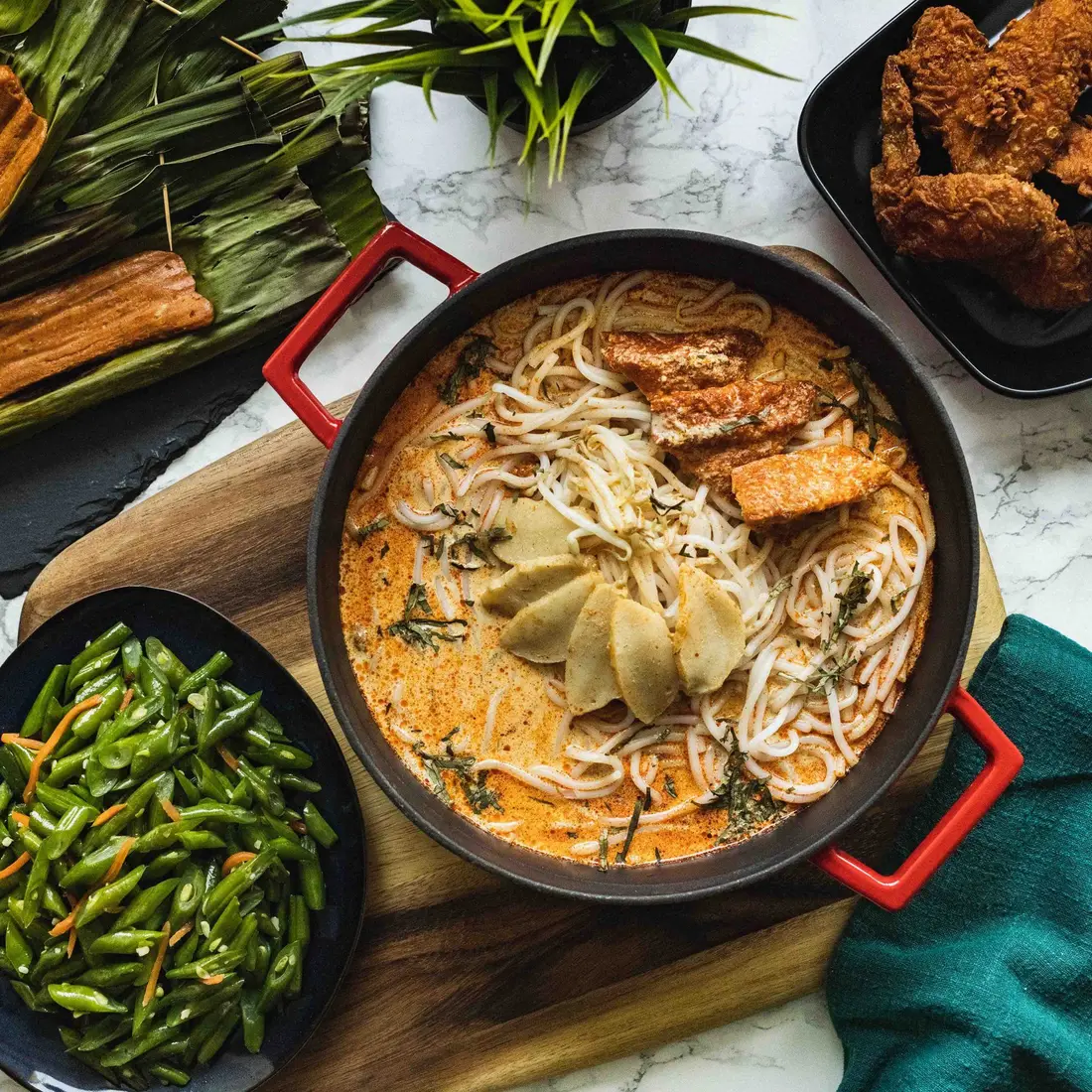 Laksa served as part of a local favourites catering spread in Singapore