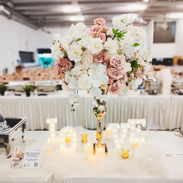 Wedding buffet catering setup with floral centrepiece in Singapore